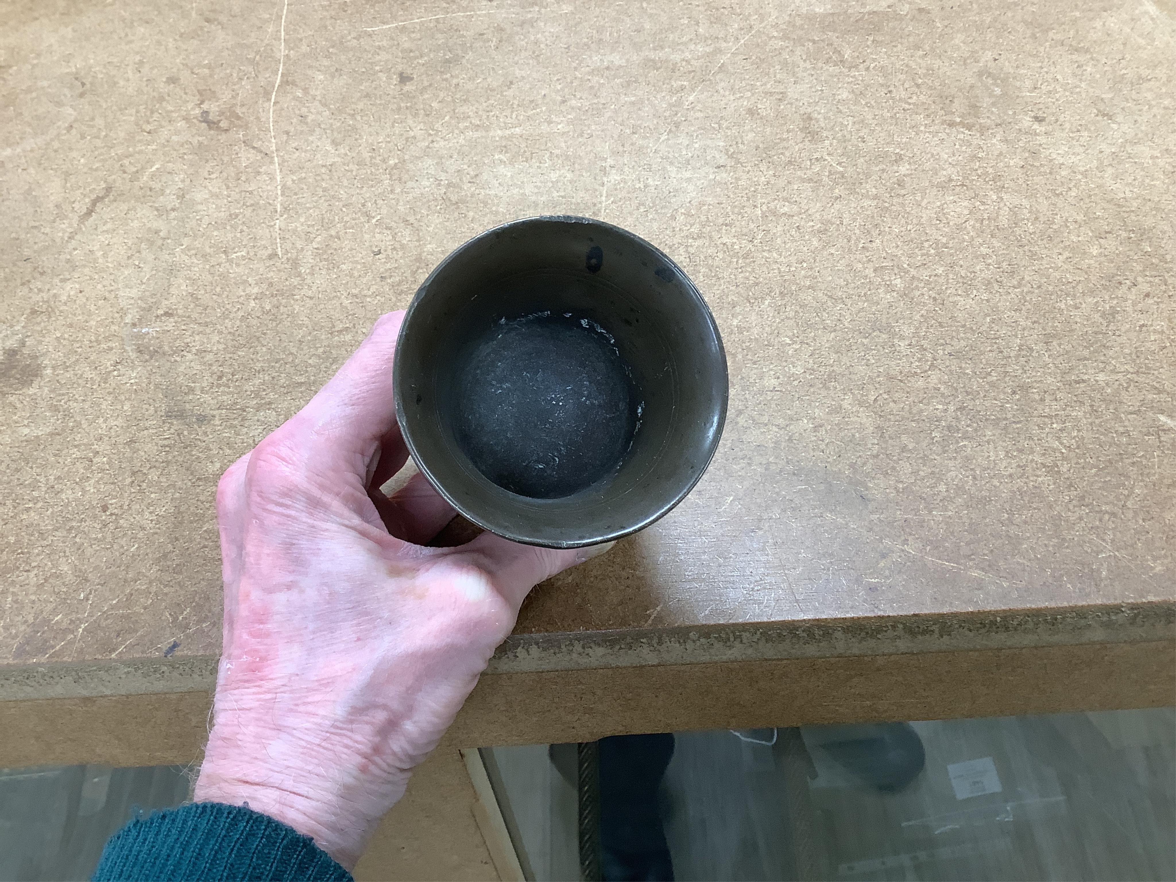 Sundry items to include a large pestle, spice grinder, flat iron on stand, bronze mortar and three other items, largest 42cm in length